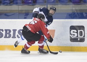 POPRAD, SLOVAKIA - APRIL 15: Finland's Teemu Engberg #18 passes the puck past Switzerland's Nico Gross #26 during preliminary round action at the 2017 IIHF Ice Hockey U18 World Championship. (Photo by Andrea Cardin/HHOF-IIHF Images)